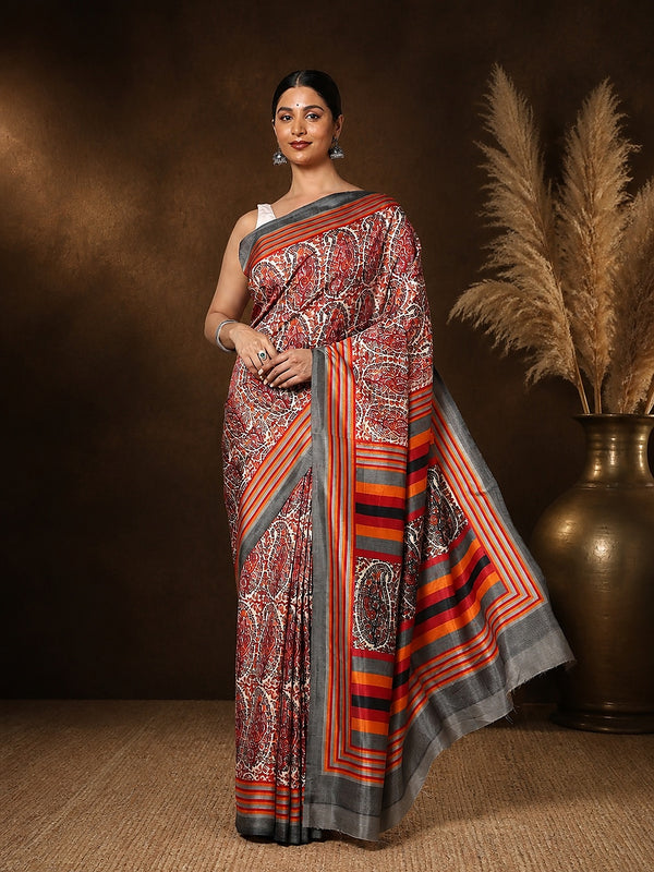 Red, white and grey paisley printed saree with multi-coloured horizontal striped borders, styled with a reference blouse.