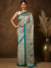 Off White and teal printed Kashmiri silk saree with a fine kalamkari-style figurative print of florals, elephants and peacocks, and a wide teal border of repeating elephants and birds.