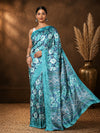 Teal and turquoise floral printed Kashmiri Silk saree with a wide geometric diamond-band pallu in white.