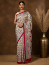 Off White printed Kashmiri silk saree scattered with small Madhubani-style floral sprigs, a wide vertical pallu panel of red elephants, and a narrow deep-red border.