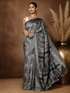 Grey, black and white large paisley printed saree with a grey-toned striped border and end-panel, styled with a reference blouse.