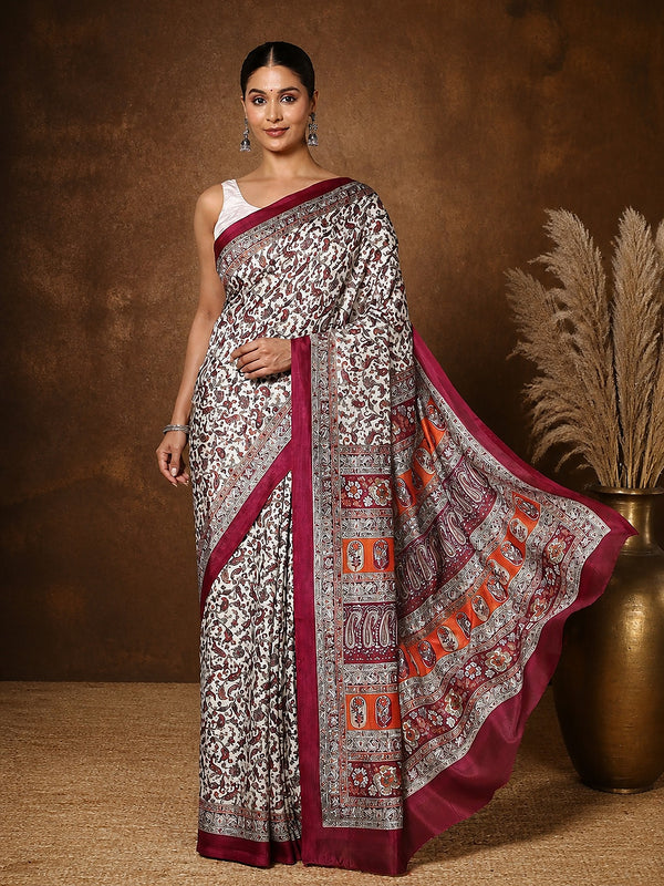 Off white Kashmiri Silk printed saree with a dense paisley and floral print in maroon and orange, a wide banded pallu and a medium maroon border.