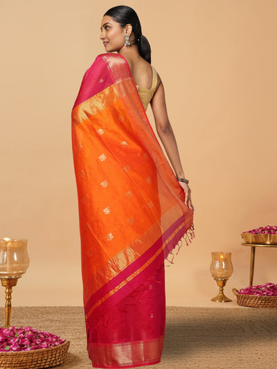 Handloom Maheshwari silk saree, fuchsia body with flower buti, orange pallu with lotus buti and a golden zari border